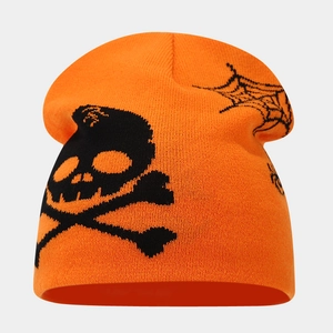 Detail of orange knitted beanie featuring a black skull and spider web Halloween motif