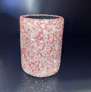 Close-up of pink and silver rhinestone encrusted cylinder makeup brush holder