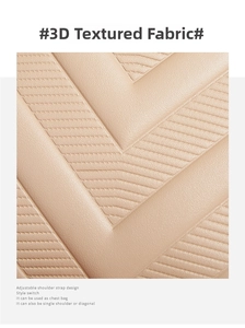 Close-up of beige handbag featuring textured V-quilted faux leather and adjustable strap