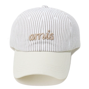 Detailed macro view of the 3D amis cursive embroidery on a striped baseball cap
