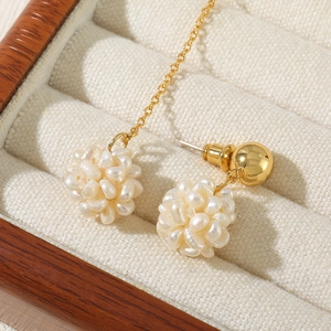 Elegant vintage pearl cluster earrings with long gold tassel chains in a jewelry box