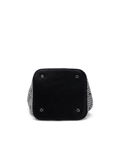 Detail view of the silver rhinestone bucket bag showing the black leather base and metal studs