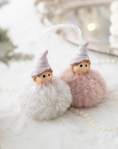 Close-up of plush Christmas angel girl ornaments in pink and white with sequin details