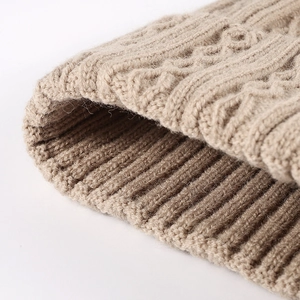 Oatmeal cable knit beanie for women featuring warm ribbed cuffs and cozy texture