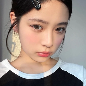 Classic black side hair clip shown on a model with a minimalist vintage aesthetic