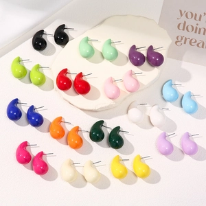 Macro shot of colorful teardrop stud earrings in multiple vibrant lacquer finishes