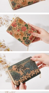 Detail view of cork wallets with floral and tropical prints featuring golden zippers