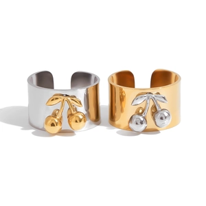 Adjustable wide band rings with cherry charms in polished gold and silver finishes
