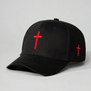 Detail of red cross embroidery on black cotton canvas baseball cap with 3D texture