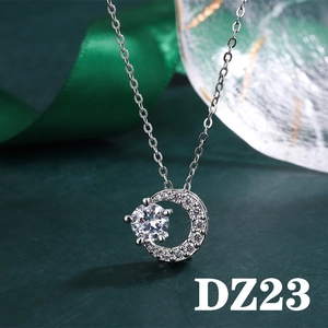Macro shot of silver crescent moon pendant with 2ct round zircon and elegant green ribbon
