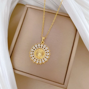 Elegant gold titanium necklace featuring a religious medal pendant with shimmering crystals
