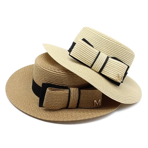 Chic flat top straw boater hat with black ribbon and metallic M charm detail