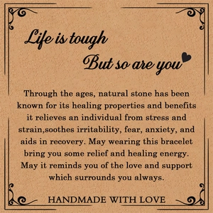 Detail of pink zebra jasper stone bracelet displayed on a vintage card with healing text