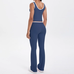 Vue arrière d'un ensemble de yoga bleu marine avec pantalon évasé et débardeur à liseré blanc