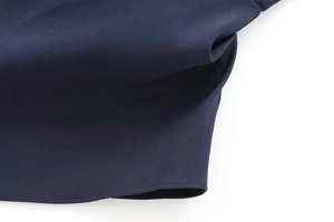 Detail of dark blue twill fabric showing professional stitching and textile texture