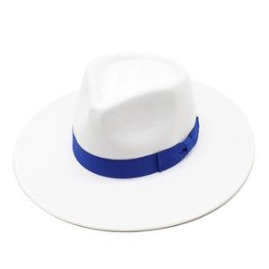 Close-up of white wool jazz hat featuring a royal blue decorative ribbon and bow