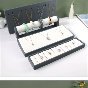 Detailed view of grey and beige jewelry display stand set for rings and necklaces