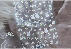 Detail view of 5D floral and rabbit nail art stickers with delicate white flowers