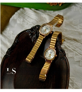Detailed view of vintage gold women's watches with fluted bezel and link bracelet