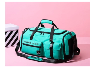 Detail view of Turquoise fitness bag with waterproof nylon fabric and firm FIRM ABS branding