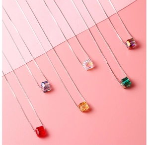 Macro shot of colorful cube crystal pendants in various gradients on silver metal chains