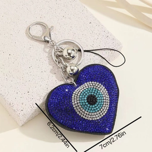 Macro detail of blue rhinestone heart evil eye keychain with dimension measurements