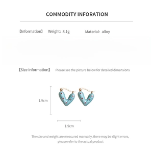 Detailed view of blue heart earrings with red polka dots and material specifications