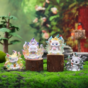 Detailed group view of four luminous fox figurines on mossy wood in a forest setting