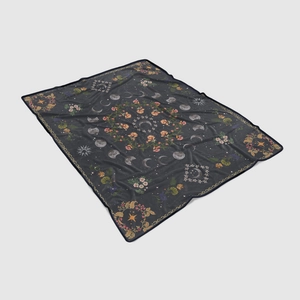 Detail of soft flannel blanket featuring mystical moon phases and vintage floral pattern