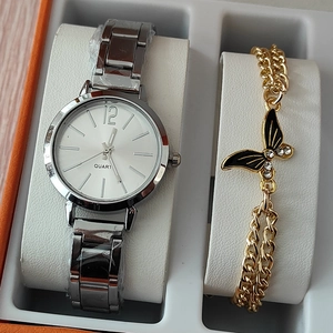 Detailed view of silver quartz watch and golden butterfly bracelet in a gift box