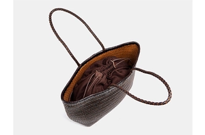 Detail of hand-woven tote bag showing the drawstring inner lining and texture