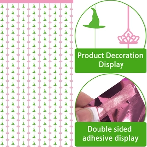 Pink foil curtain background with green witch hats and crowns for magic themed party decor