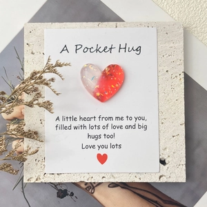 Macro shot of gradient glitter resin heart attached to a Pocket Hug greeting card