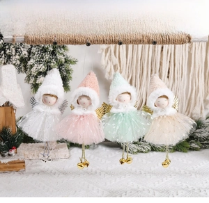 Detailed view of four angel girl ornaments with pointed hats and tulle skirts on a wooden bar