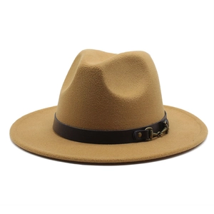Detail of camel wool fedora hat with black leather band and golden horsebit buckle