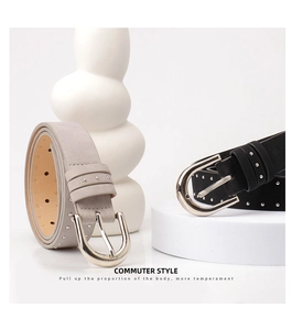 Detail of grey and black suede belts with silver rivets and vintage buckle closure