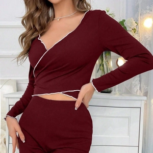 Women's burgundy ribbed knit pajamas set with V-neck wrap top and white lettuce edge trim