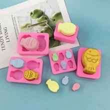 Detail of fish-shaped silicone molds for chocolate and crafts on a blue aesthetic background