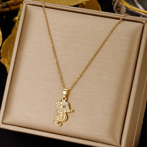 Detailed view of a gold seahorse pendant necklace with sparkling micro-pave zirconia stones