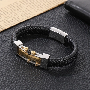 Close-up of woven leather bracelet with tricolor metal screws on vintage background