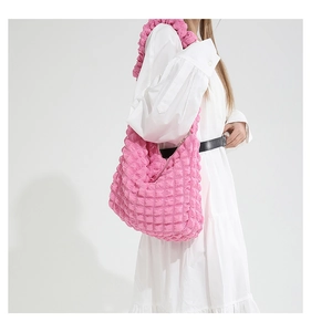 Detail view of pink bubble texture pleated fabric on large capacity shoulder bag