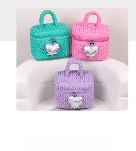 Detailed view of quilted macaron color bags with silver heart pendants and ribbon accents
