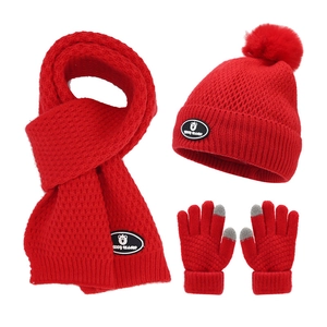 Winter kids red knit set including beanie with pom-pom, scarf, and touch gloves
