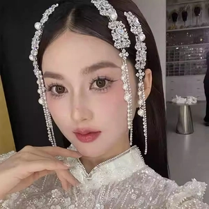 Elegant rhinestone flower and pearl tassel hair clip worn by a model in a formal dress