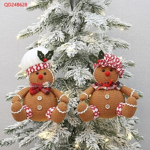 Detail of gingerbread man Christmas tree ornaments with red checkered scarves and hats
