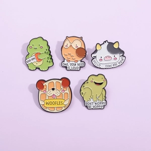 Set of 5 cartoon animal enamel pins including dinosaur, owl, cow, and frog on purple card