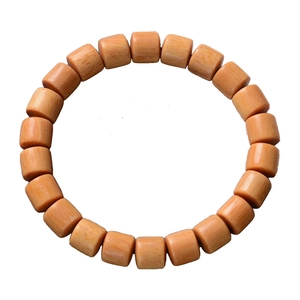 Natural orange wood prayer beads bracelet with smooth cylindrical barrel beads on white background