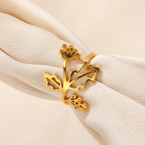 Macro shot of gold floral napkin ring with leaf design and a small clear zircon detail