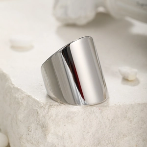 Detailed macro view of wide minimalist stainless steel ring with polished silver finish