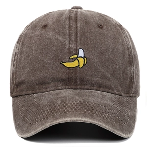 Détail macro de la broderie banane jaune sur casquette en coton lavé marron foncé